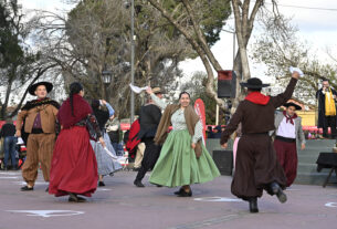 Grupo de personas vestidas con trajes folclóricos tradicionales bailando en una plaza durante el ciclo 'Domingos de Peña' organizado por el Municipio de Tigre.